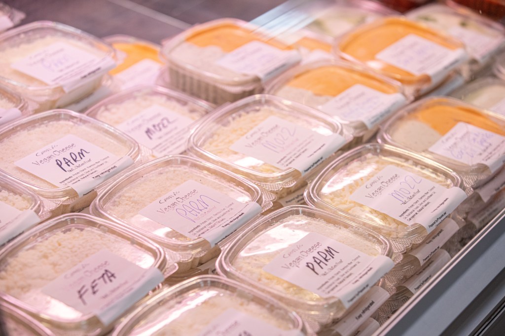 Photo of the display case of Carmela's cheeses showing feta, parm, mozz, and smoky paprika. Photo by Tracy Isaacs