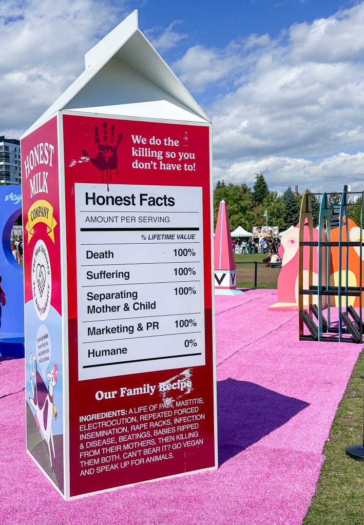 Giant milk carton that says "honest milk" on one side and has a "nutritional label" that says "honest facts: death 100%, suffering 100%, separating mother and child 100%, marketing and PR 100%, humane 0%." Photo by Tracy Isaacs